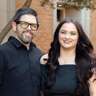 Robert, on the left, and his daughter Reagan are facing forward and smiling.