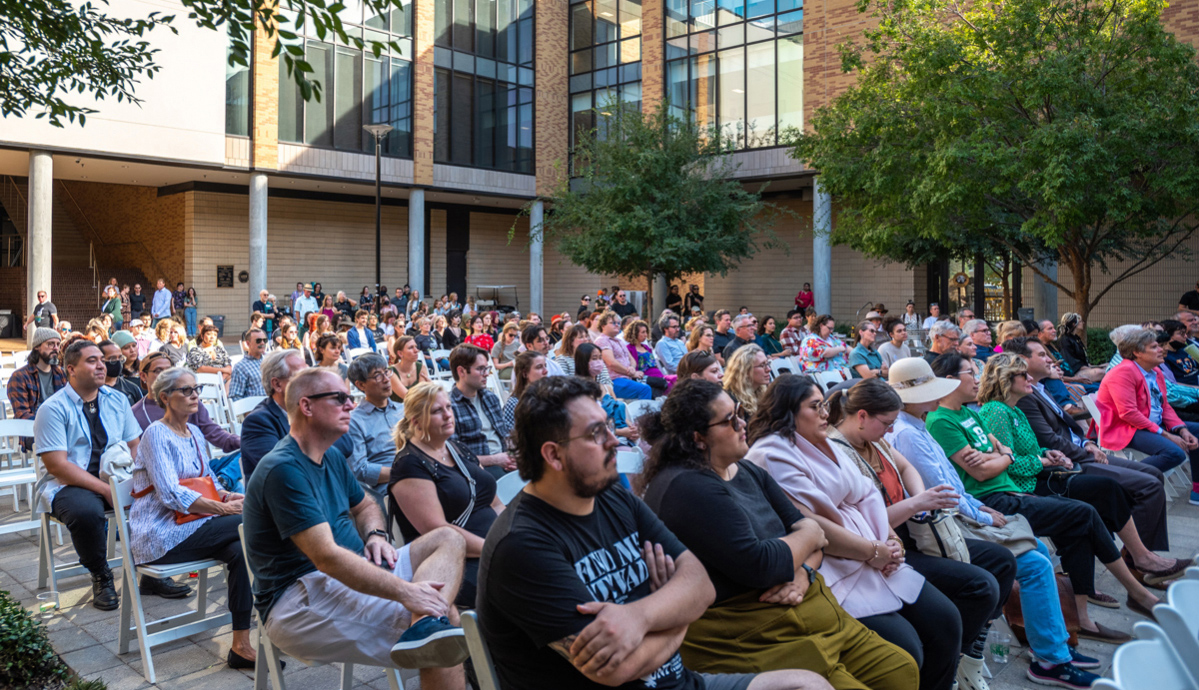 Rows of people seated in the Art Building Courtyard