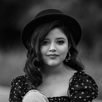 Black & white photo of a woman wearing a hat.