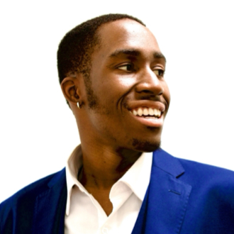 Osajere is facing to his left smiling. He has short dark hair and wears a royal blue jacket with a white shirt.