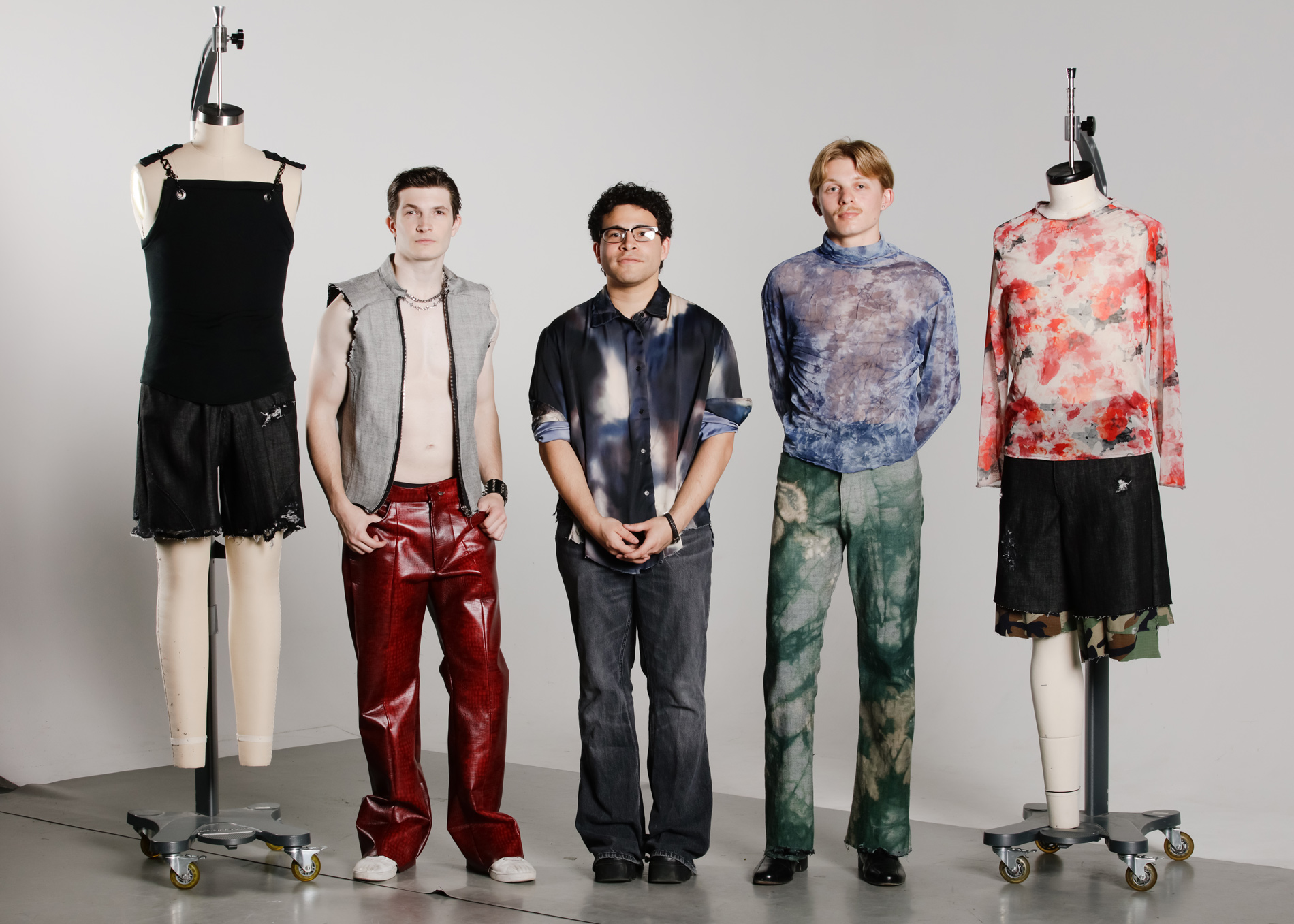 Three men, two mannequins in grungy menswear jeans and printed T-shirts.