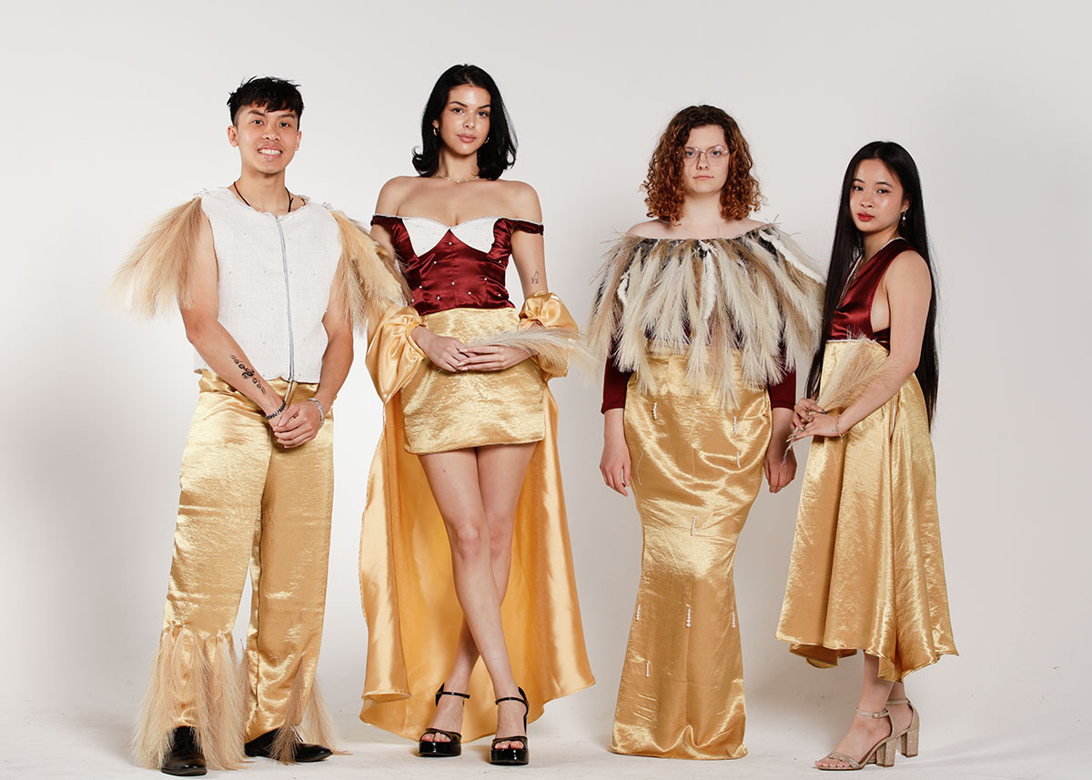 Models wear garments in golden hues inspired by Vietnamese rice fields, blending in: pearls, pampas leaves, and maroon. 