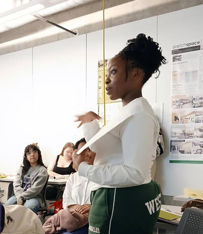 Student presenting in front of a class.