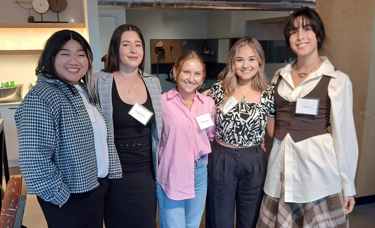 Five interior design students standing and smiling.