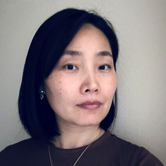 Wei Sun is facing forward. She has dark hair and wears a dark top.