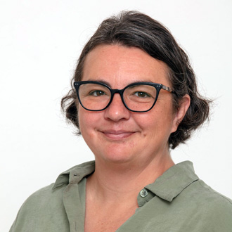 Karla facing forward, smiling, green shirt