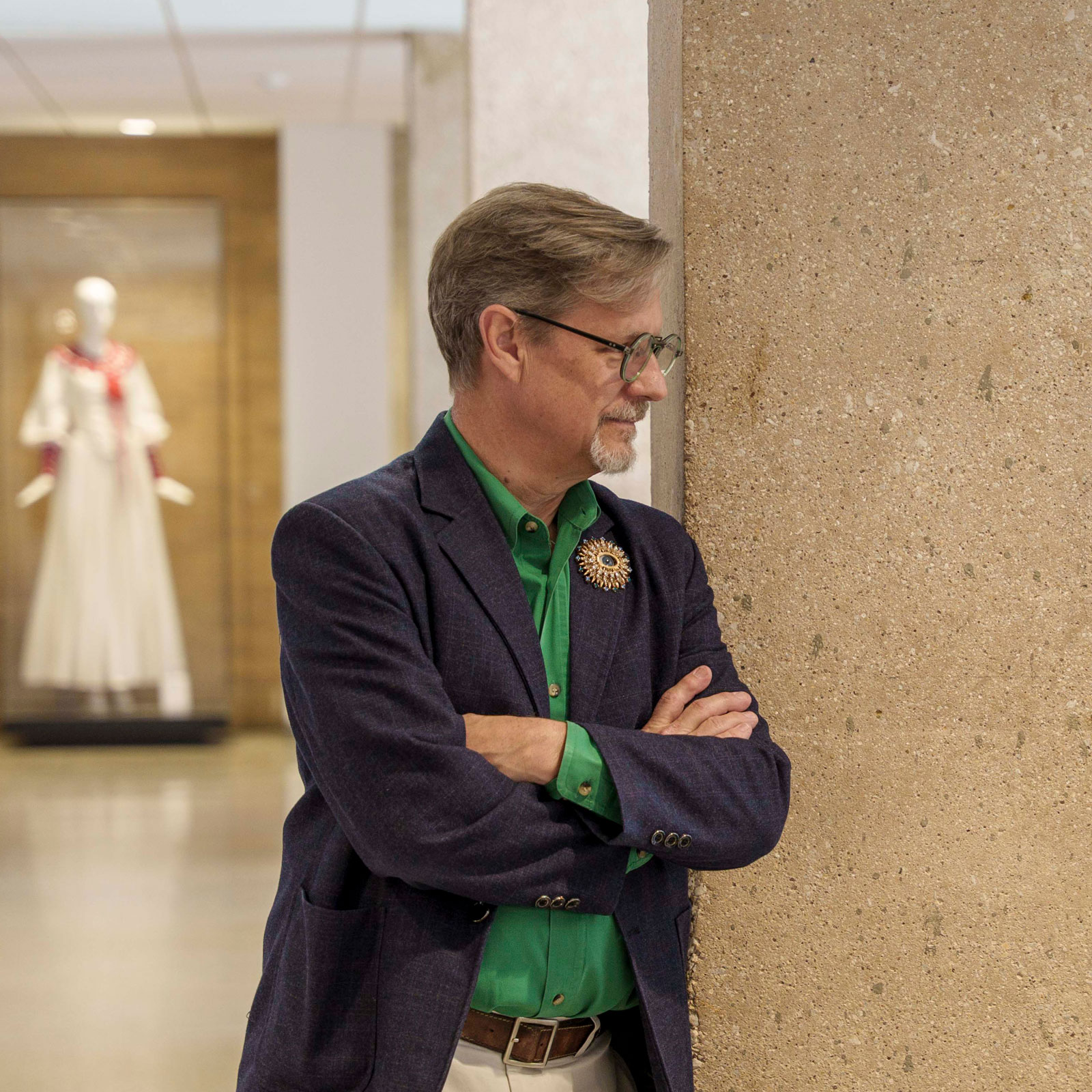 Eric Ligon in profile. He has brown hair, wears a navy-colored jacket over a dark green shirt.