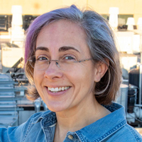 Ana Lopez smiling, wearing a blue denim top