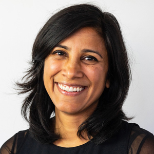 Manali facing forward, smiling, dark hair, black top