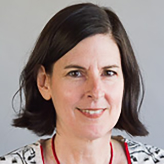 Lisa Owen is facing forward and smiling. She has short black hair and wears a print top.