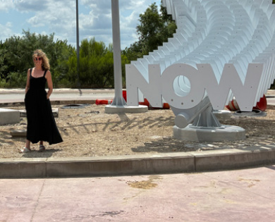 Alicia Eggert stands next to the installation of her sculpture in Fort Worth