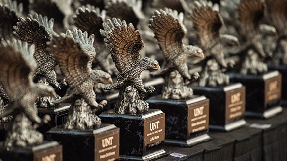 Small, brown eagle statues on black pedestals