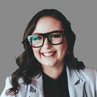 Jennifer Stanley smiling, long brown hair, black top, light gray jacket