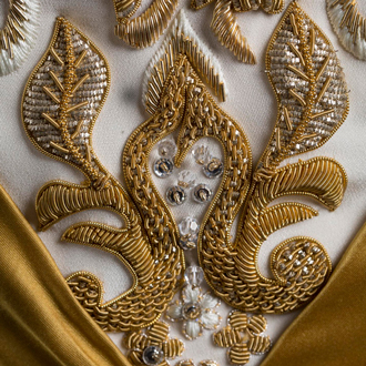 Evening dress detail with white beads and embroidery