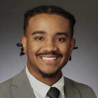 Headshot of Maurice Cruz dressed in business professional.