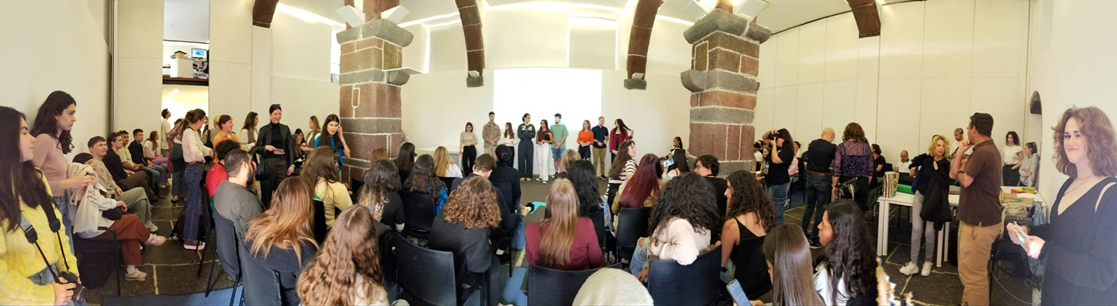 A large room with many students looking toward the presenter