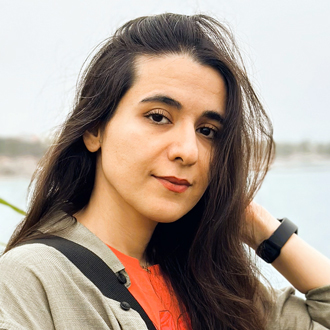 Fatemeh Zand Shahri wearing an orange-beige shirt