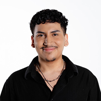 Lucas facing forward smiling, short dark hair, mustache, black shirt