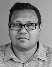 Zahid Islam, black and white photo, short dark hair, wearing glasses