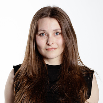 Keeley facing forward, light brown hair, black sleeveless top