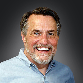 David Wilgus facing forward, smiling, short brown hair, blue shirt