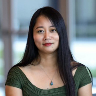 Li facing forward, long black hair, olive green top