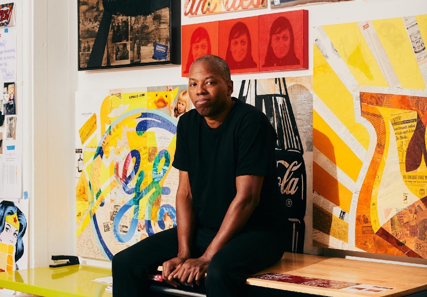 Cey Adams sitting on a table. Photo by Robert Bredvad