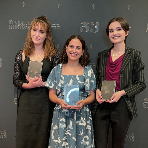 Kristina Armitage, Gina Lecca, Ashley Owen holding their awards, gray Dallas Show '53 background