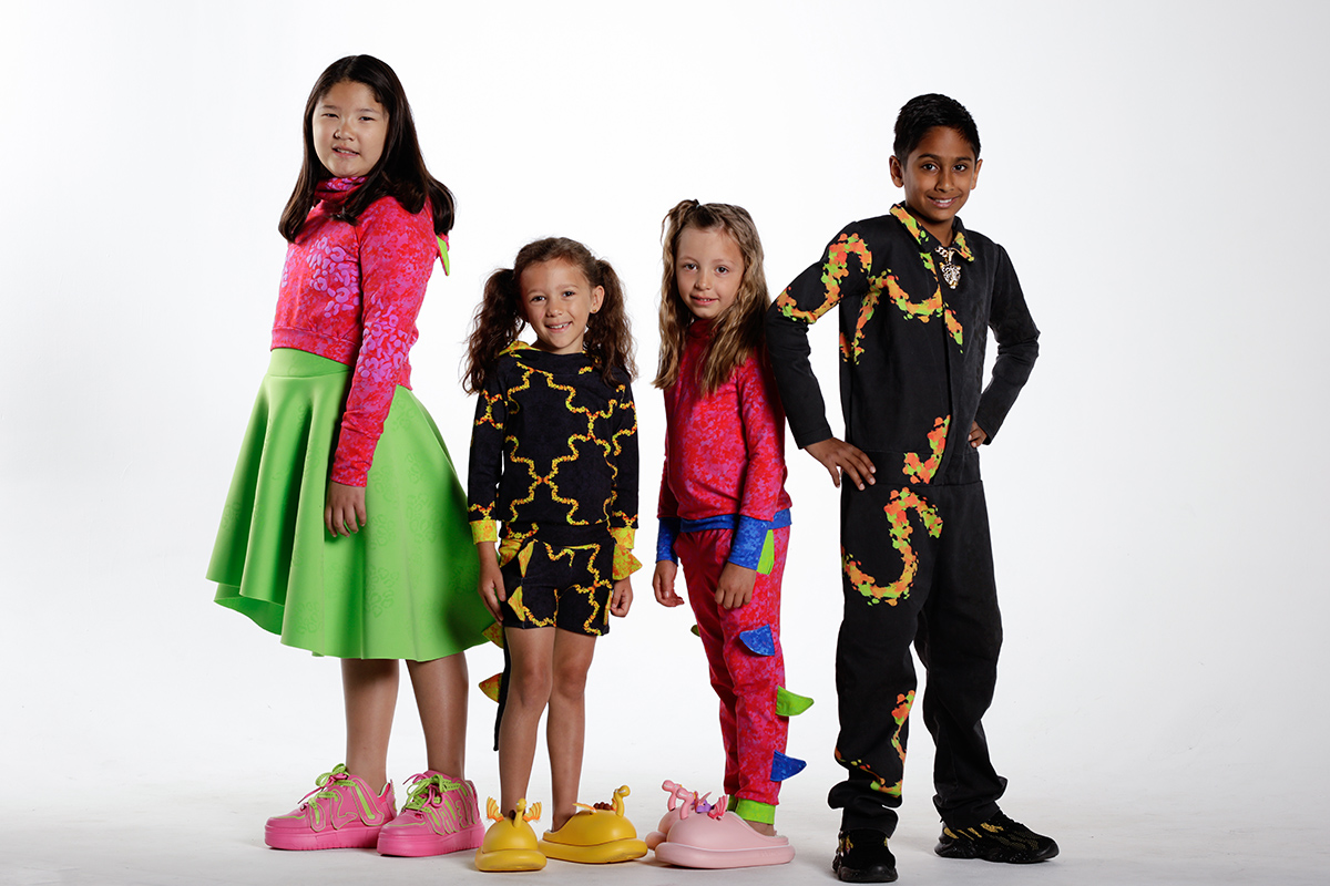 A photo of four children in clothing.