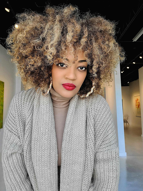 Daisha looking forward, large Afro, gray sweater