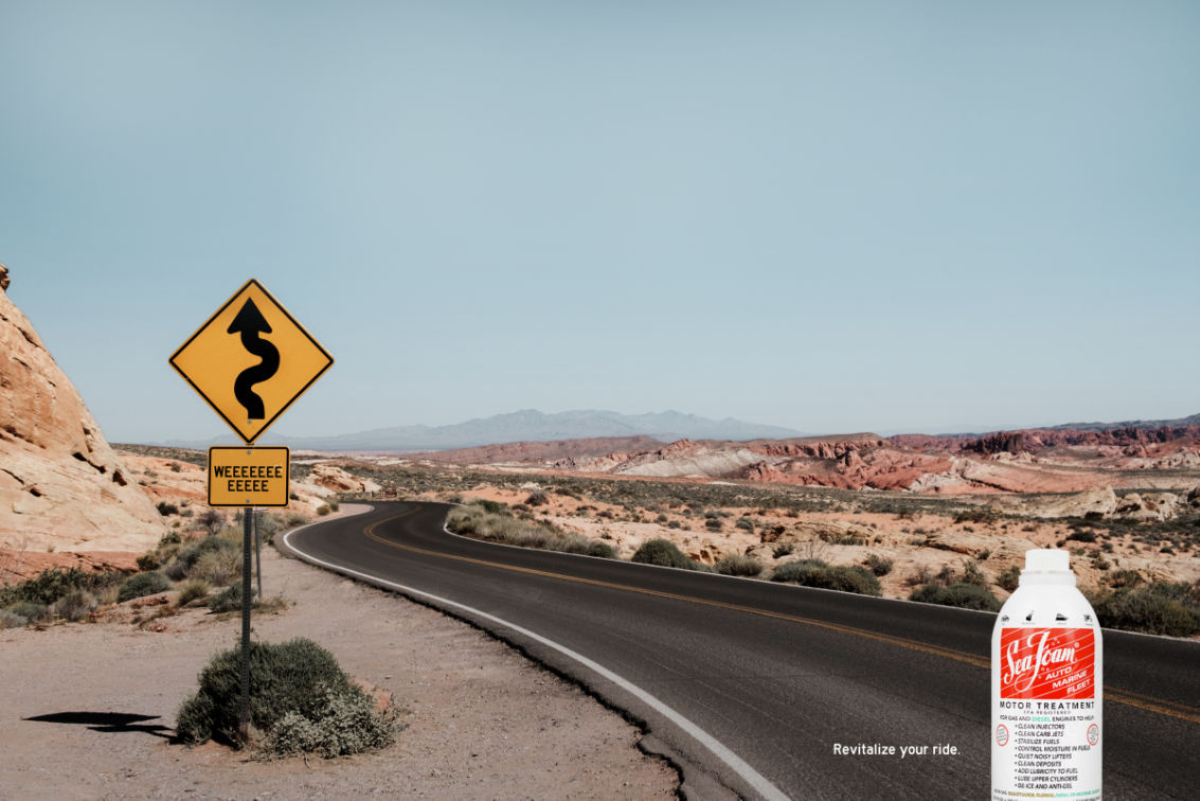 Scenery is a desert with a long winding road. A yellow "curved road" traffic sign reads "weeeeee." Headline reads "revitalize your ride" with an image of the product next to it.