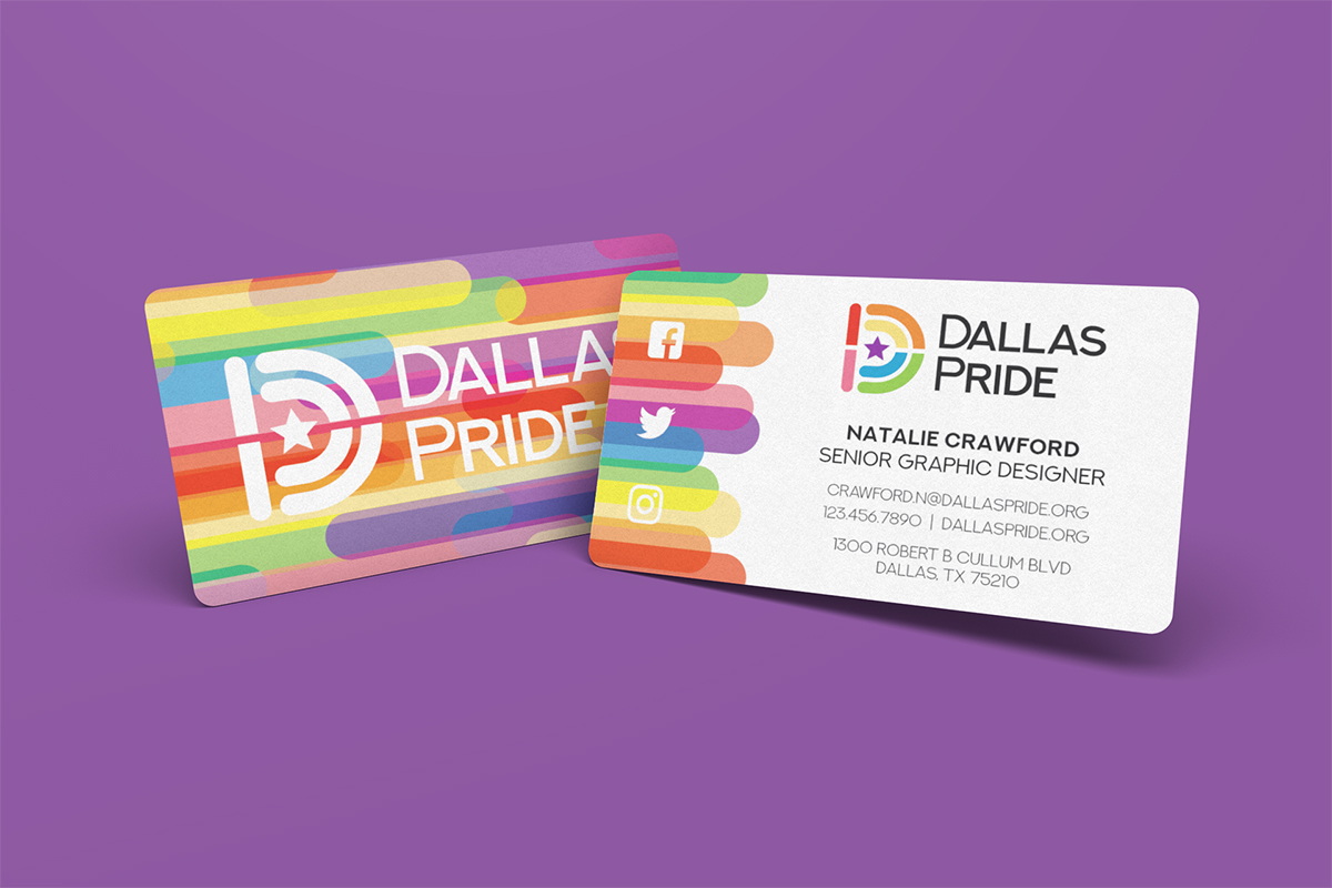 On a purple background is two business cards side by side, slightly overlapping eachother. The left side shows the front of the card, which is rainbow with the new Dallas Pride Logo. The right side shows the back of the card with the individual's name.