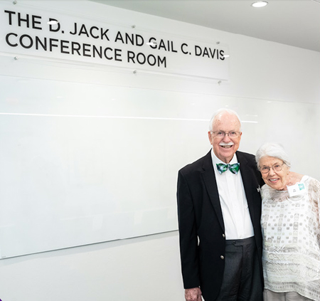 Jack and Gail standing in the conference room named for them.