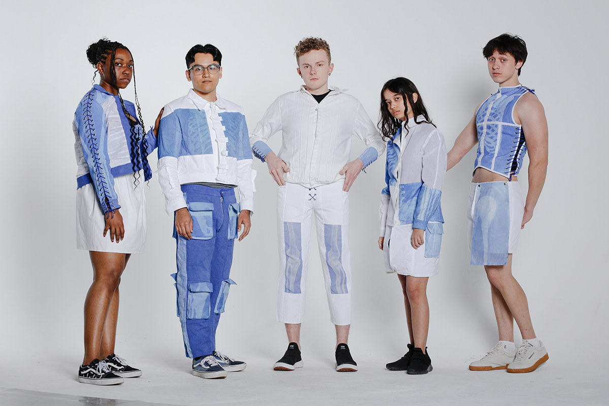 Collection line-up featuring the 5 looks on male and female models featuring blue and white cotton fabrics and classic and modern silhouettes.