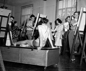 1940 black-and-white photo of students in front of easels with a model in the foreground