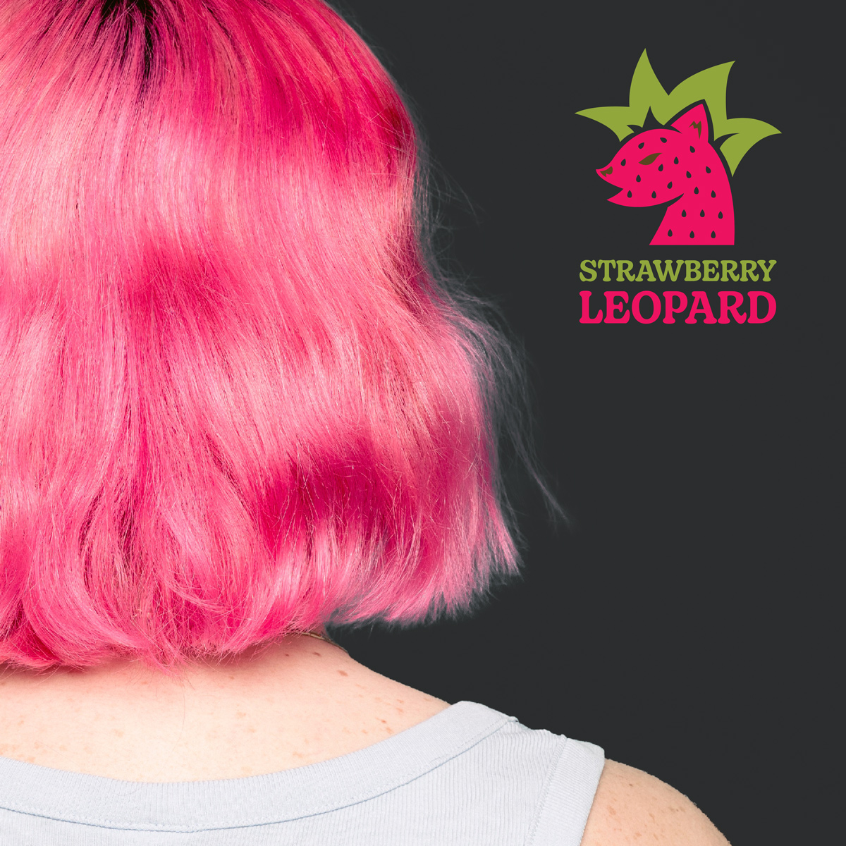 Photograph of a person with bright pink hair, Strawberry Leopard logo  featured on the right side of the photo.
