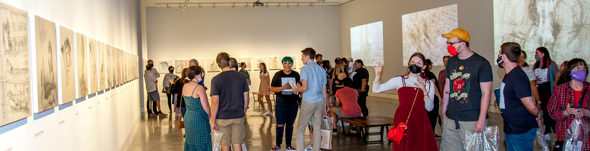 Visitors in the CVAD gallery looking at art on the walls