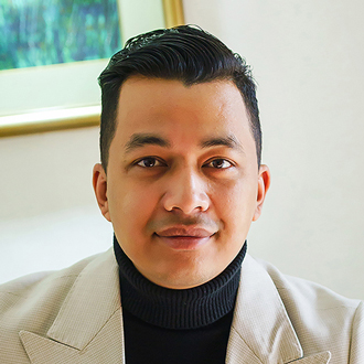 Sudit Maharjan in a beige blazer on a black t shirt 