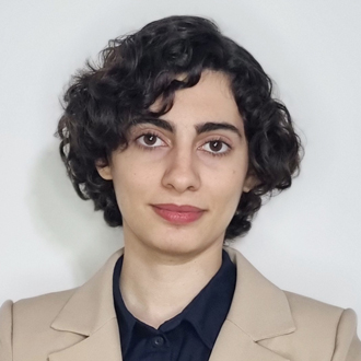 Zeinab Moghaddasi in beige blazer looking into camera