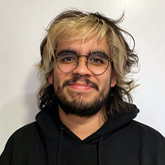 Emilio in a black hoodie facing forward,smiling