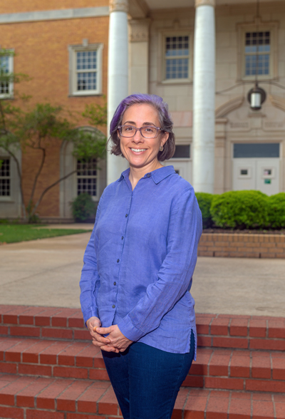 Ana Lopez standing in front of Hurley Building