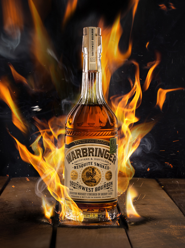 Warbringer: A western saloon bottle surrounded by flame. The label depicts a rooster triumphantly standing over another rooster.