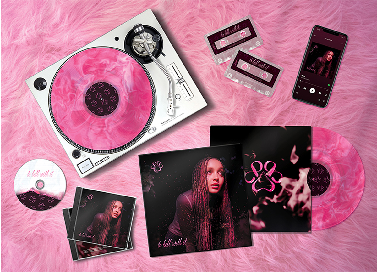 A bright pink monochrome scene of marbled vinyls, vinyl covers, cd covers, mixtapes, and  old-school record player laying on a fuzzy carpet floor.