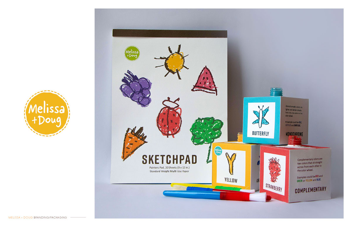 On the left, a circular logo with stitching patterns outlining the circle and handwritten type spelling out Melissa and Doug. To the right, is a family shot of a sketchbook, three painting cubes, and paint brushes.