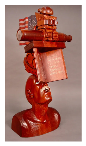 Sculpture of a still life of various objects made of Honduran mahogany