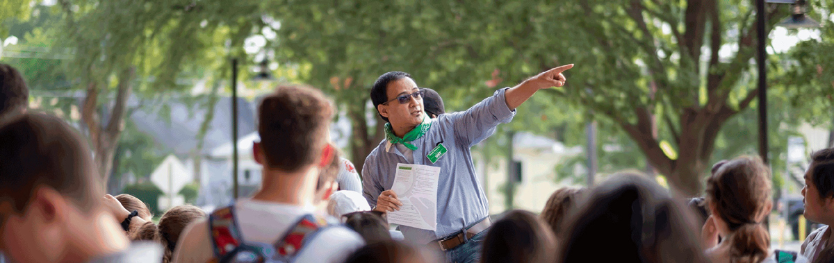 Binod Shrestha pointing the way to direct a group of students