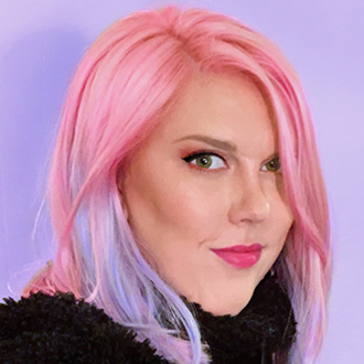 Three-quarter view of Megan, pink hair, black top