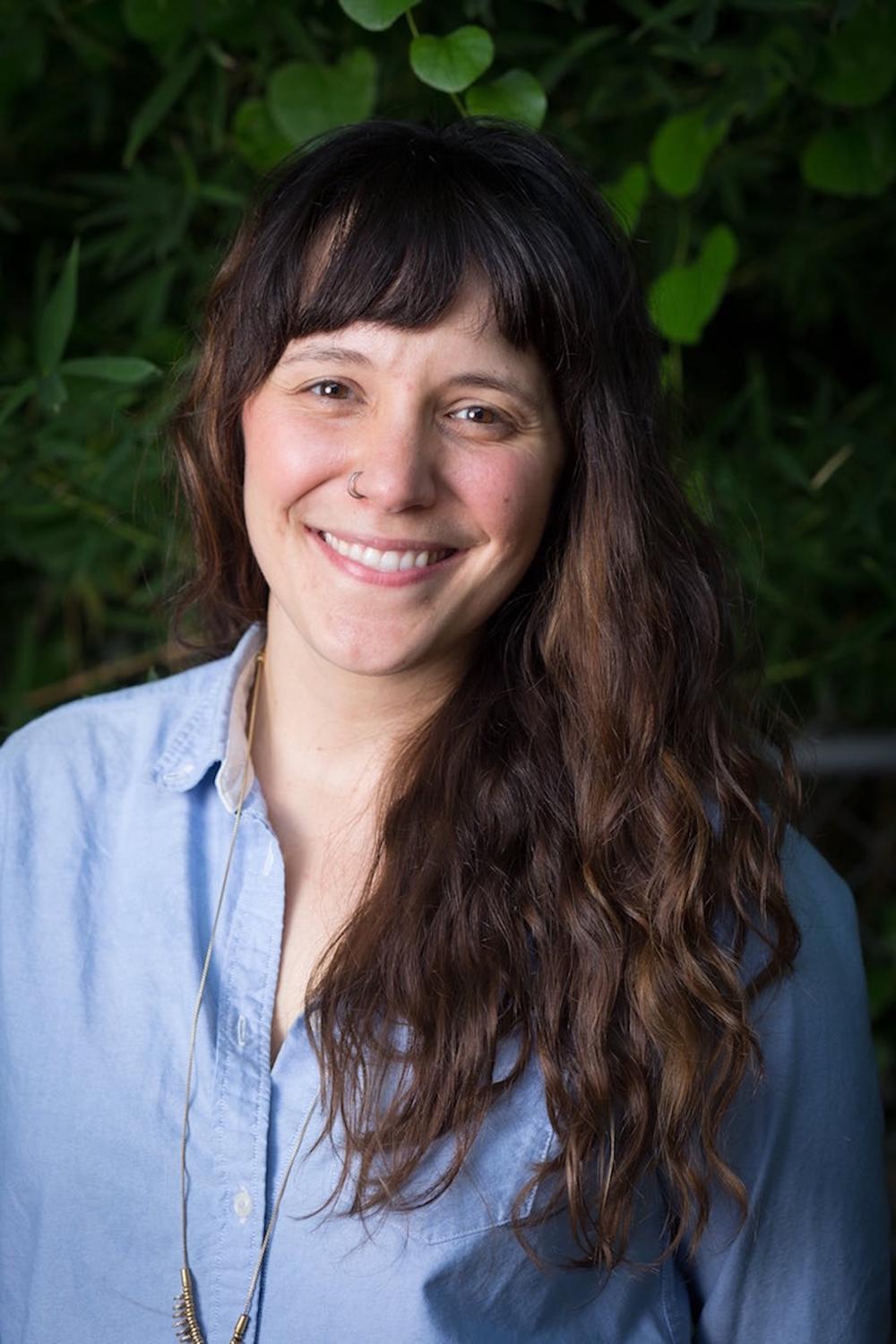 Katherine Sobering, long brown hair, wearing a light blue shirt, smiling