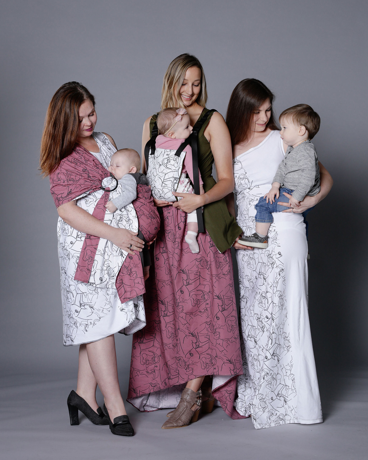 Three women each holding a baby. All are modeling JenLey Designs