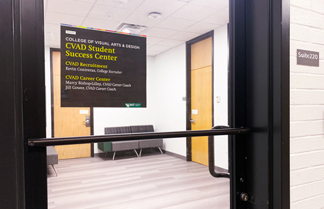 Glass door with a sign that says CVAD Student Success Center, Suite 220